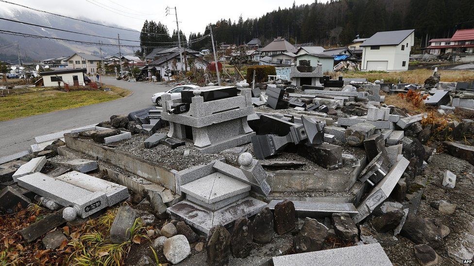 Gravestones lie in a pile at a burial ground after they were toppled by the earthquake in Hakuba, some 300km north-west of Tokyo, Nagano prefecture (23 November 2014)