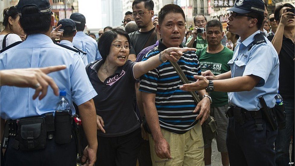 A woman gestures towards pro-democracy protesters (not pictured) in the Mongkok district of Hong Kong on October 6, 2014