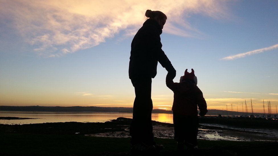 Mother and son holding hands
