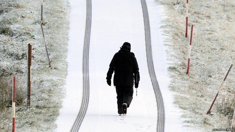 Man walking through snow