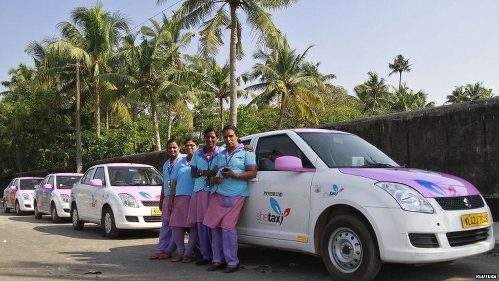 Female drivers from the "She Taxi" service pose next to a taxi on a road in the southern Indian city of Kochi, December 12, 2014. The alleged rape of a woman passenger by an Uber taxi driver once again spotlights the risks of India's transport system, which fails to keep women safe