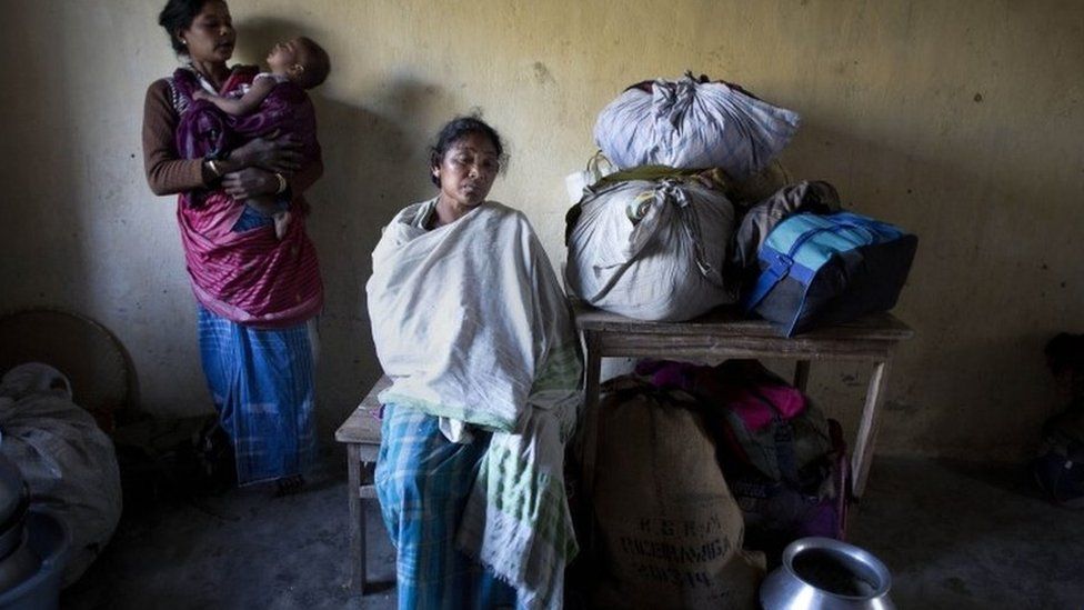 Indian tribal settlers, who fled from their village Phuluguri after an indigenous separatist group attack, take refuge in a local school, in Shamukjuli village in Sonitpur district of Indian eastern state of Assam, Wednesday, Dec. 24, 2014