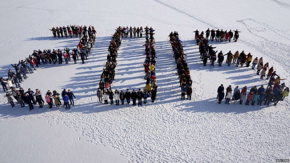 Students form "2015" standing on snow to welcome the upcoming New Year at Shenyang Agriculture University in Shenyang, Liaoning province, 31 December 2014.