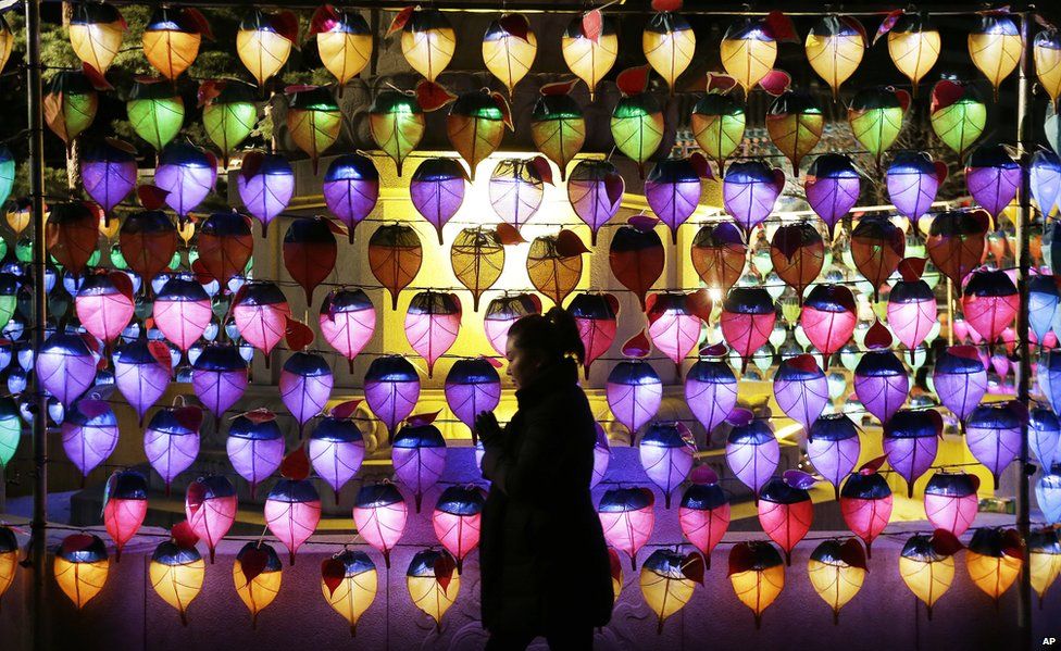 A woman prays during New Year celebrations at Jogye Buddhist temple in Seoul, South Korea, Thursday, 1 January 2015.