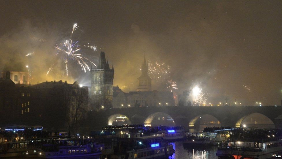 Fireworks explode above the Charles Bridge during the New Year celebrations in Prague (01 January 2015)
