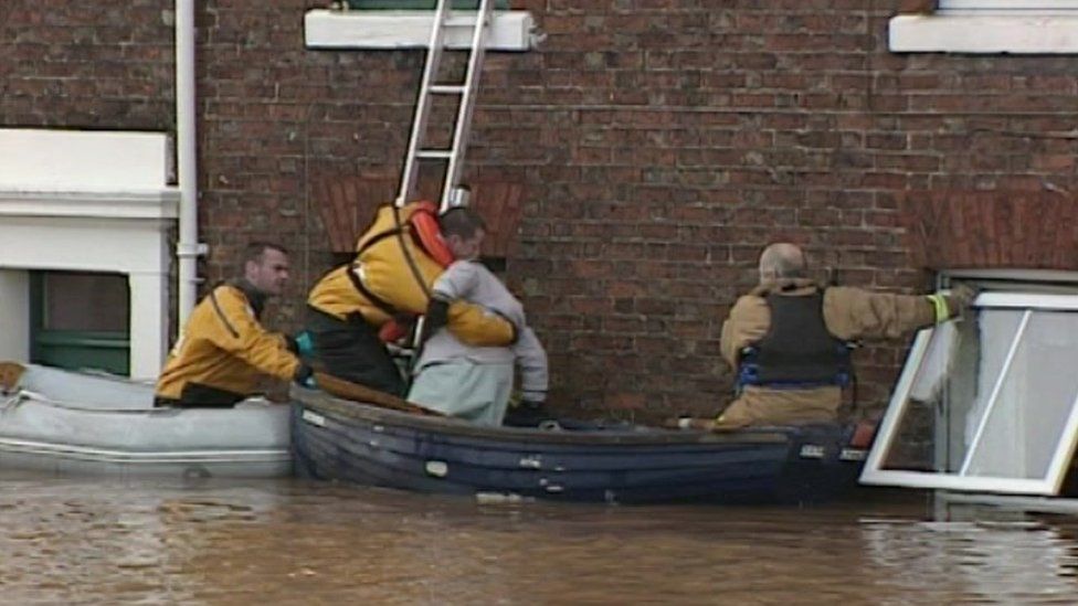 Firefighters saving flooded residents