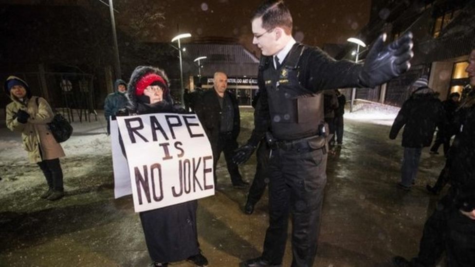 Bill Cosby receives standing ovation despite protests BBC News