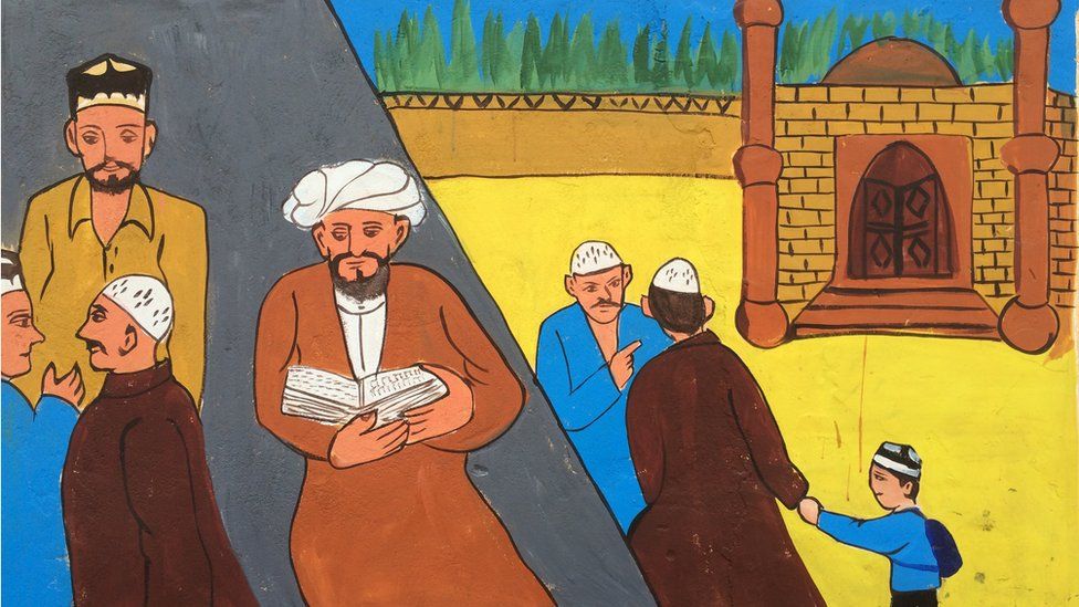 A mural is painted on the walls next to a mosque in the old Silk Road district of Kashgar