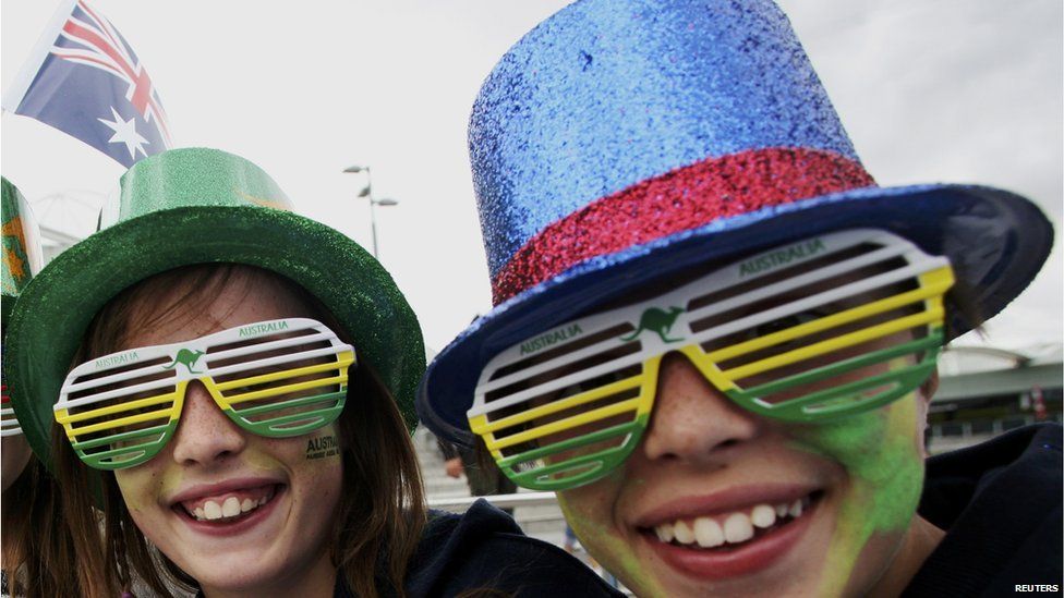 Two tennis fans wear colourful hats and glasses as part of Australia Day celebrations in Melbourne on 26 January, 2015