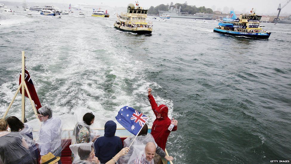 People brave the wet weather to celebrate Australia Day on one of the Sydney's beloved ferries on 26 January, 2015 in Sydney, Australia