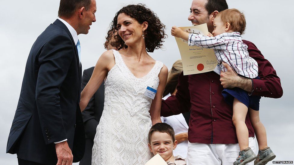 Prime Minister Tony Abbott gives certificates to the Garrido family from Spain at the Citizenship Ceremony on January 26, 2015 in Canberra, Australia.