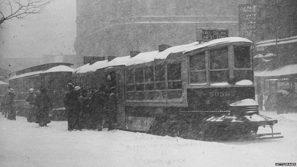 People boarding street cars in winter, New York City, New York, circa 1900.