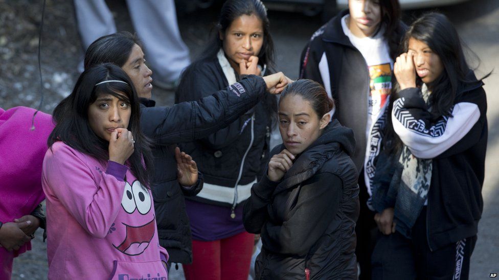 Relatives and friends wait outside the police cordon where a gas truck exploded at a maternity and children"s hospital in Cuajimalpa, a Mexico City borough, Thursday, Jan. 29, 2015.