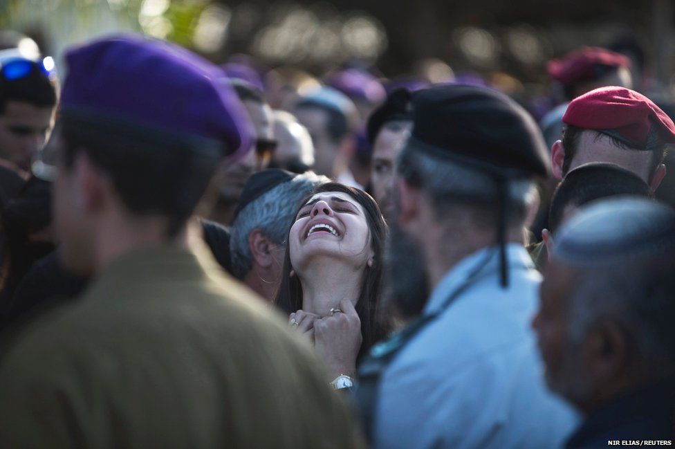 Sahar, the girlfriend of Israeli soldier Dor Nini mourns during his funeral in a cemetery at Shtulim village near Ashdod