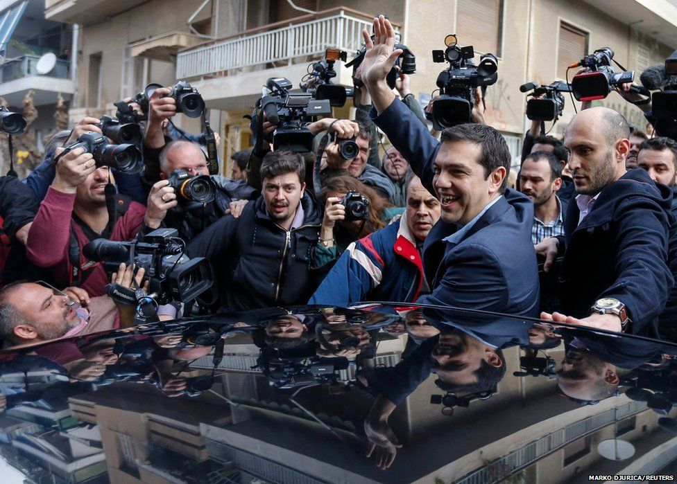 Opposition leader and head of radical leftist Syriza party Tsipras waves as he leaves a polling station in Athens