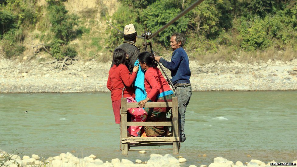Villagers using a wire bridge in Charaudi