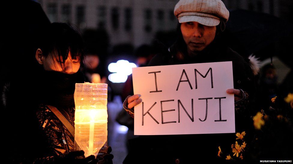 People holding a silent vigil in memory of Kenji Goto