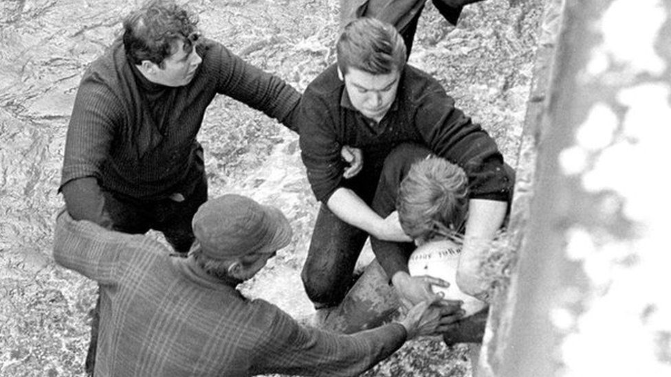 Competitors grapple for the ball in Henmore Brook during the Shrovetide football match in Ashbourne 1969