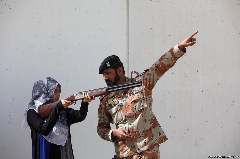 Pakistan Rangers soldier gestures as he instructs a female student