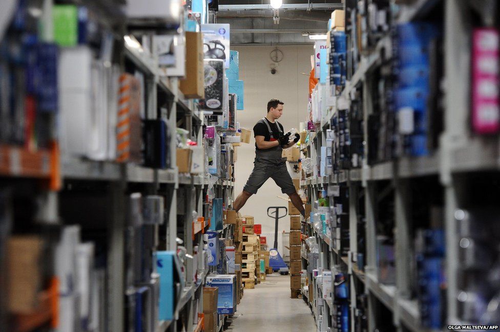 An employee gathers items in a warehouse
