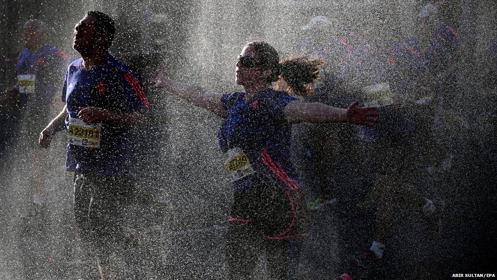 Runners pass through a water refreshment point during the Tel Aviv Marathon in Israel
