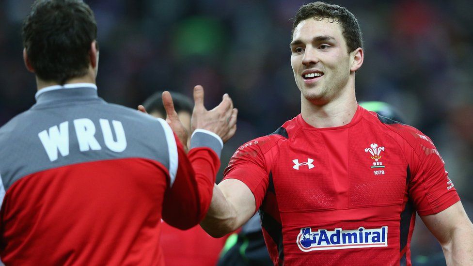 Mike Phillips and George North celebrate for Wales