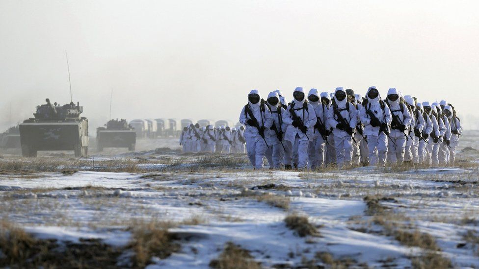 Soldiers and vehicles of the People's Liberation Army (PLA) Marine Corps march on a snow-covered field during a military drill in Jilin province, file pic from January 2015