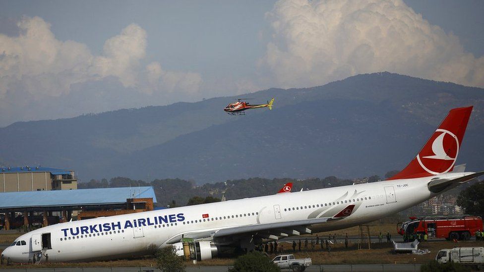 A Turkish Airlines plane lies on a field after it overshot the runway at Tribhuvan International Airport in Kathmandu 4 March 2015