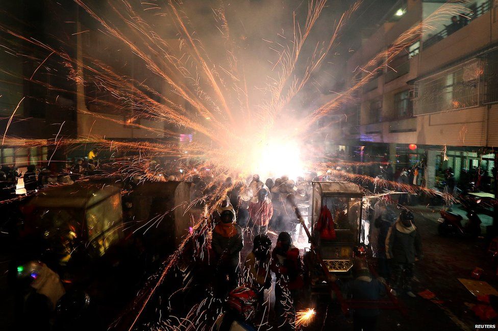 Firecrackers explode during the Beehive Rockets Festival in Tainan