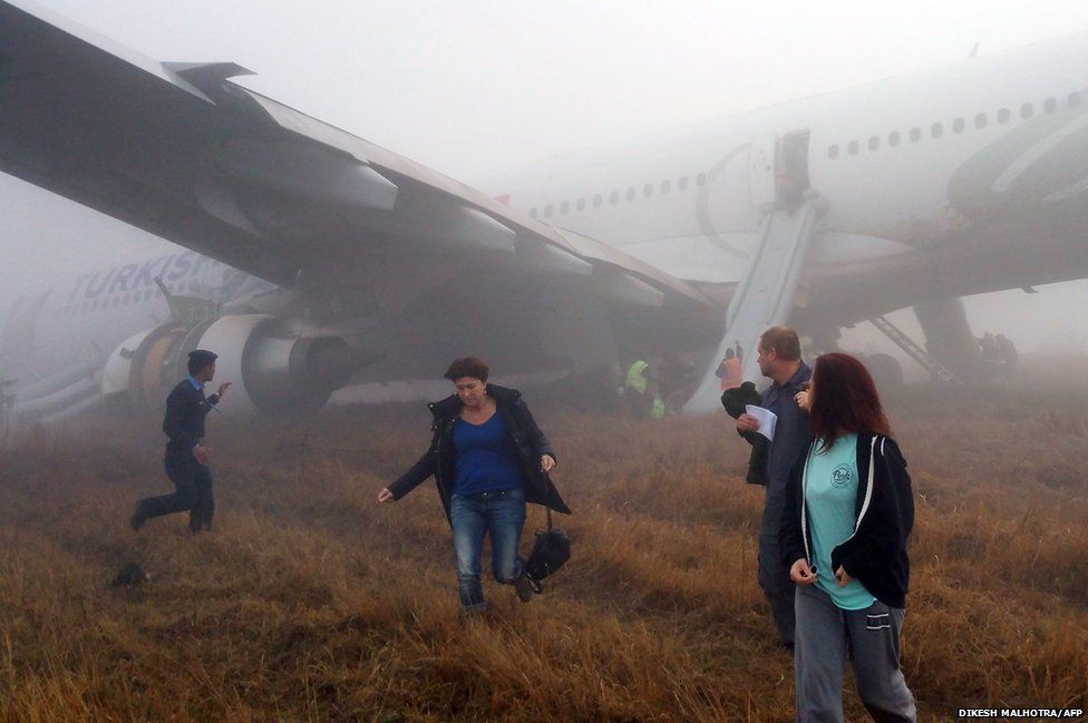 Passengers walk away from a Turkish Airlines plane