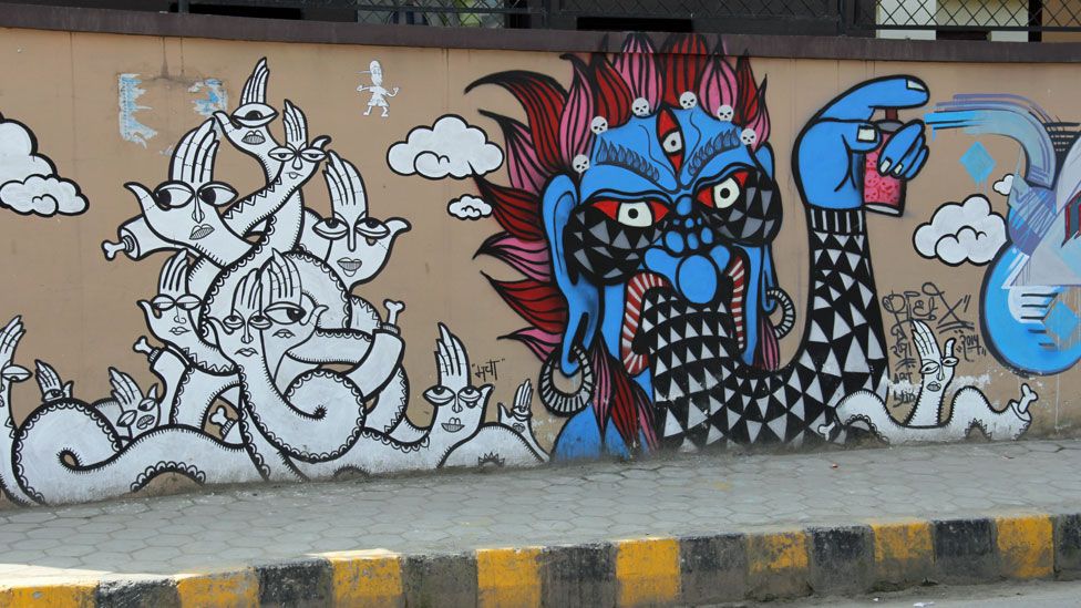 One of these deities is pictured spray-painting graffiti.