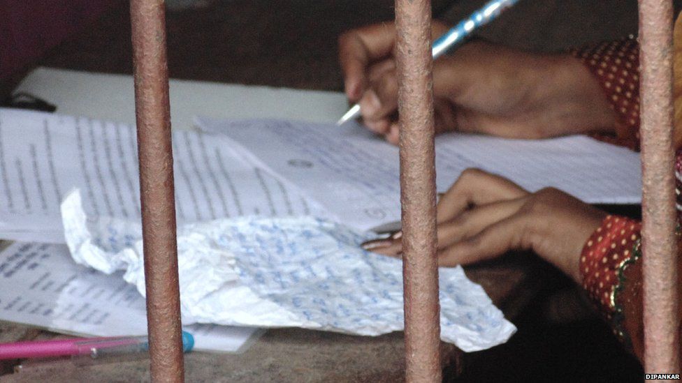 A student writes during an exam