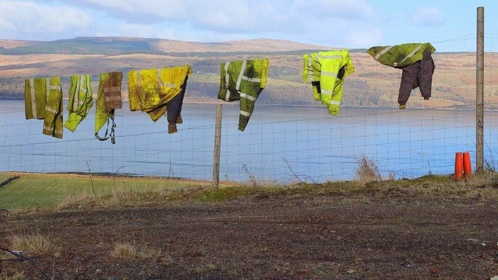 Work jackets on a wire fence