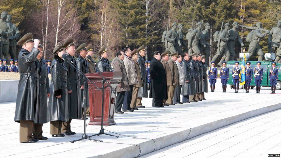 North Korean officials lined-up on a mountain