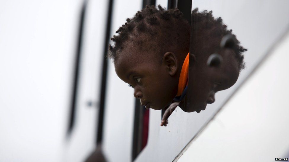 A child peering out of the window of a coach in Durban, South Africa - Sunday 19 April 2015