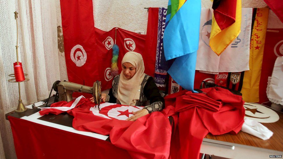 Woman sewing Tunisian flags, Tunis - Friday 17 April 2015