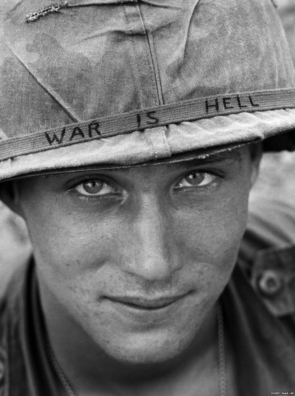 An unidentified American soldier wears a hand written slogan on his helmet in June 1965