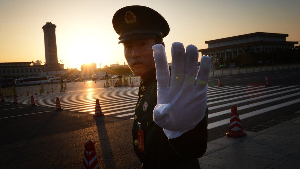 Chinese paramilitary policeman reacts outside the opening session of the Chinese Communist Party's five-yearly Congress at the Great Hall of the People in Beijing on 8 November 2012