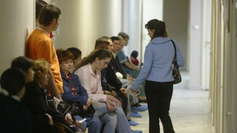 People sit in a hallway at the Saratov regional AIDS centre, 2006