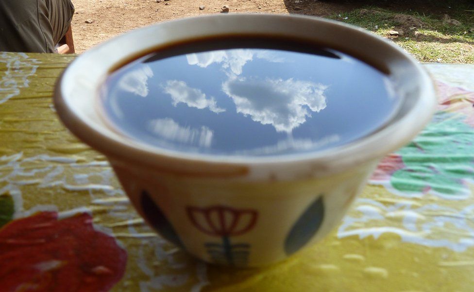 sky reflected in a cup of Ethiopian coffee
