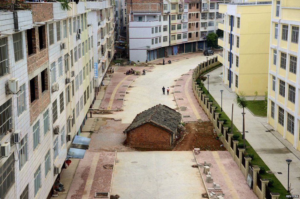 A nail house sits in the middle of a road under construction in Nanning, Guangxi Zhuang Autonomous Region