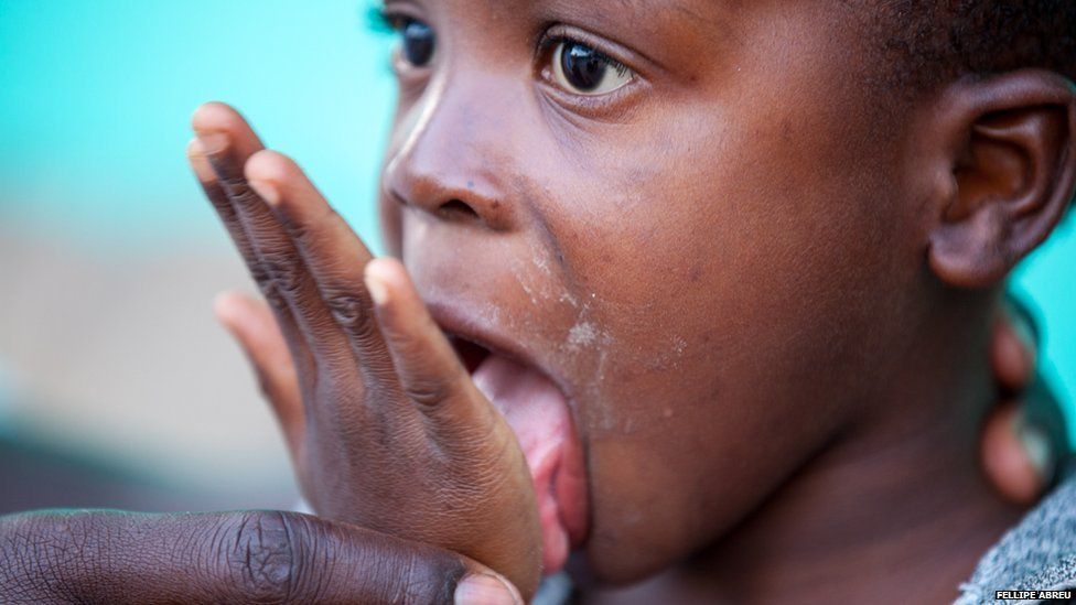 A child licking salt off his hand