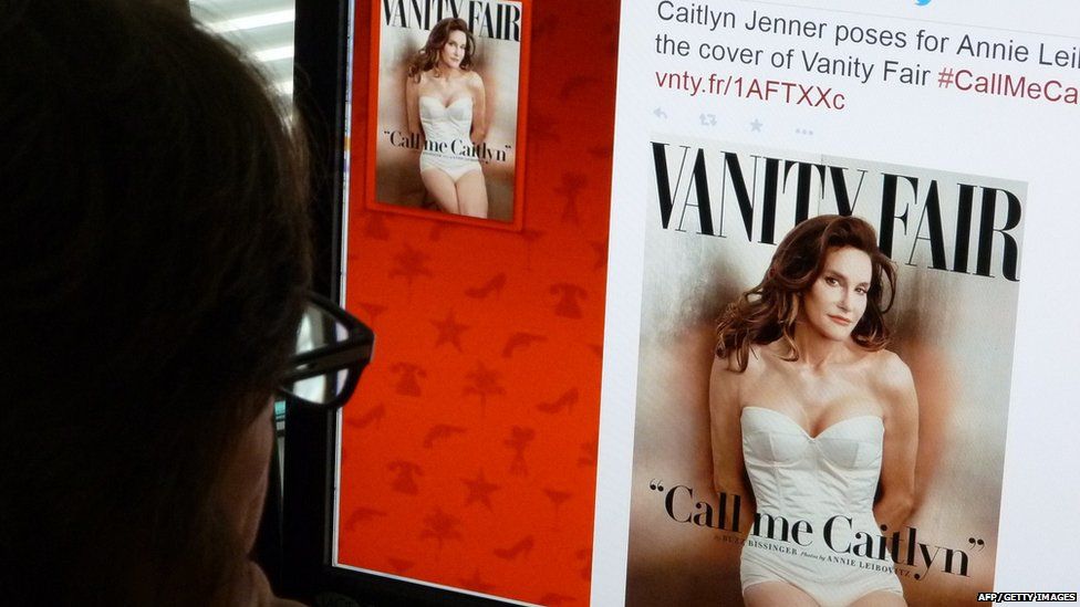 Someone looking at a screen showing Caitlyn Jenner on the cover of Vanity Fair