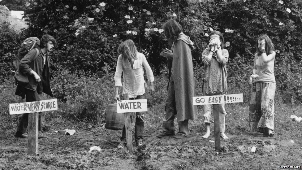 People washing by water pipes