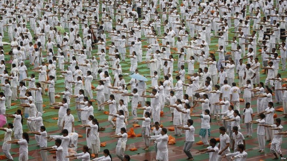 Indian yoga practitioners take part in the Yoga rehearsal camp for the International Yoga Day in heavy rain at Jawaharlal Nehru Stadium in New Delhi, India, 14 June 2015.