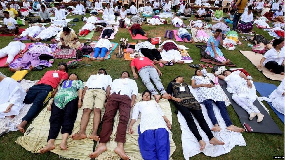 Yoga enthusiasts take part in an initiative themed "The Sun Never Sets on Yoga", in support of International Yoga day organised by Art of Living in Bangalore, India, 13 June 2015