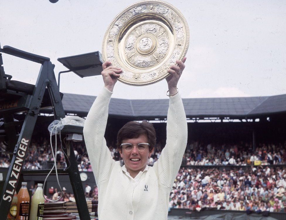 Billie Jean King holding up the winners plate at Wimbledon