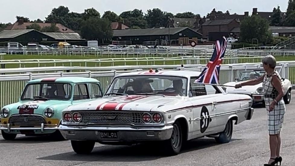Mayor of Sefton Cllr June Burns waves off an historic Ford Galaxie 7 the car which won the final race on the Aintree Grand Prix circuit 60 years ago - the Mini Cooper on the right was also in the race that day