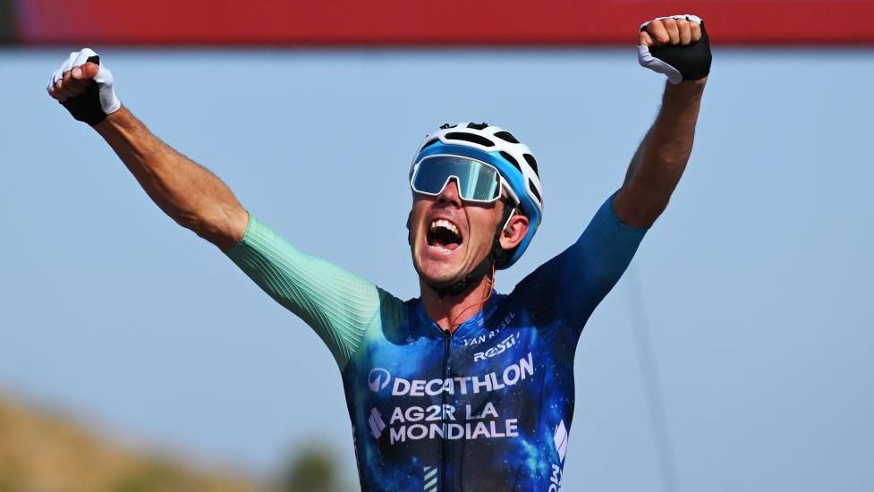 Australian cyclist Ben O'Connor raises his arms in celebration after winning stage six of the 2024 Vuelta a Espana