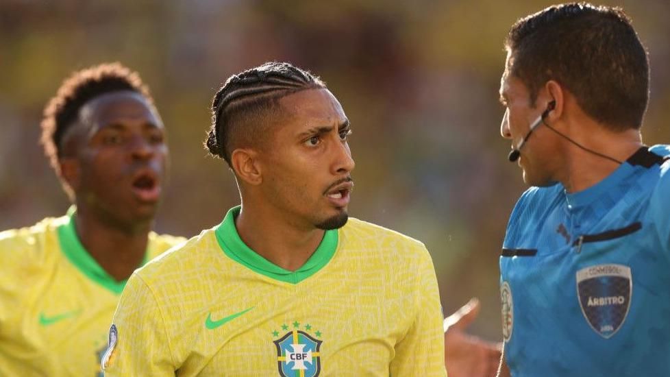 Brazil forward Raphinha complains to the referee
